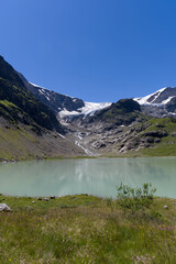 Fototapeta na wymiar Beautiful scenic view of Stone Glacier with glacier lake in the foreground at Swiss mountain pass Sustenpass on a sunny summer day. Photo taken July 13th, 2022, Susten Pass, Switzerland.