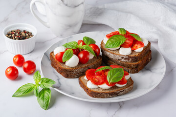 Bruschetta with mozzarella, tomatoes and basil. Vegetarian food. Healthy eating