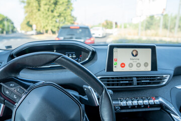 Calling from a modern concept car. Mobile phone connected with main car system while driving