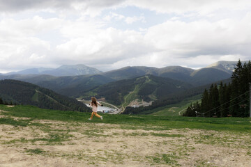 Tourist young girl child on the top of the Carpathian mountains Ukraine Bukovel. Vacation concept...