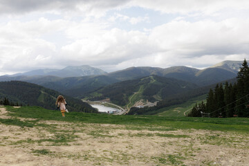Tourist young girl child on the top of the Carpathian mountains Ukraine Bukovel. Vacation concept...