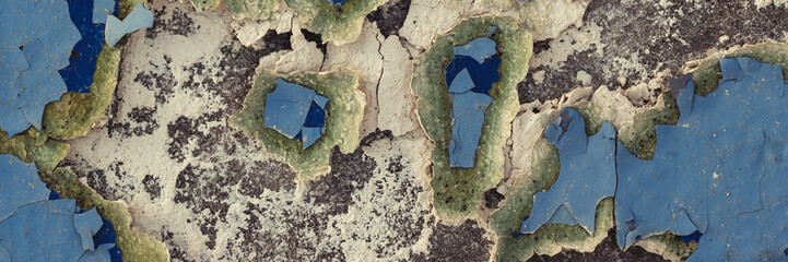 Peeling paint on the wall. Panorama of a concrete wall with old cracked flaking paint. Weathered...