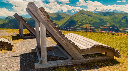 Fototapeta na wymiar Details of a wooden relexation bench at the famous Schattberg mountain, Saalbach-Hinterglemm, Salzburg, Austria