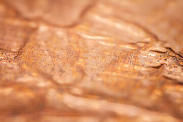 Extreme closeup of crumpled brass foil texture