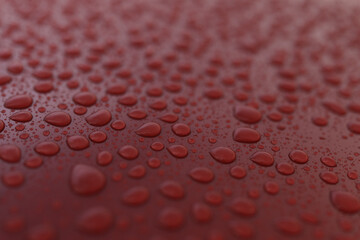Wet red car with hydrophobic coating