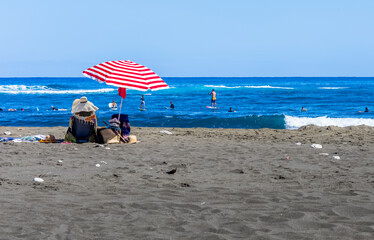 person on the beach of l’Etang-Salé, Reunion island 