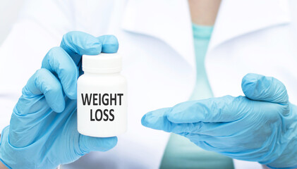 Weight Loss text on a white can of medicine in the hands of a doctor, a medical concept