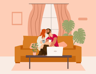 A man and a woman are sitting on the sofa and looking at the laptop screen. Freelance or studying concept. Young family