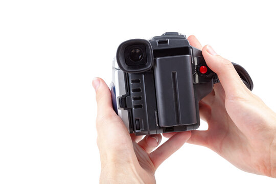 Man holding a simple film camcorder device in hands, old portable movie camera, first person pov recording video fp point of view, isolated on white background, retro object cut out Filmmaking concept