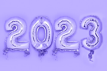 Balloon Bunting for celebration of New Year 2023 made from Silver Number Balloons. Holiday Party Decoration or postcard concept with top view and copy space.