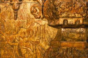 Background of a gilded wooden iconostasis made in the 16th century. The ancient carved iconostasis...
