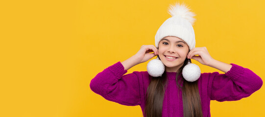 cheerful kid in hat with snowballs on yellow background. Banner of christmas child girl, studio kid...