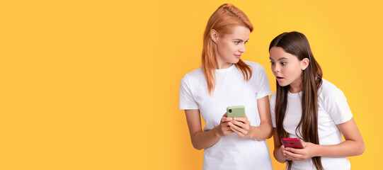 Mother and daughter child banner, copy space, isolated background. emotional mom and child girl chatting online using modern smartphone, application.