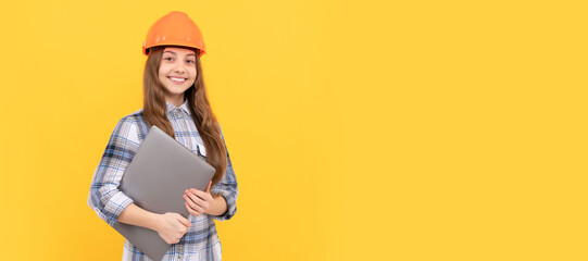 Engineer teenager girl. happy teen girl in helmet and checkered shirt holding computer, modern life. Child in hard hat horizontal poster design. Banner header, copy space.