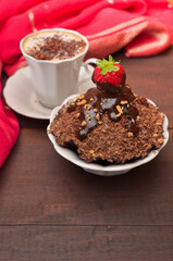 Dessert with strawberries and a cup of cappuccino