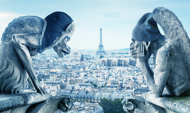 Gargoyles feeling cold, Paris, France. Energy crisis concept.