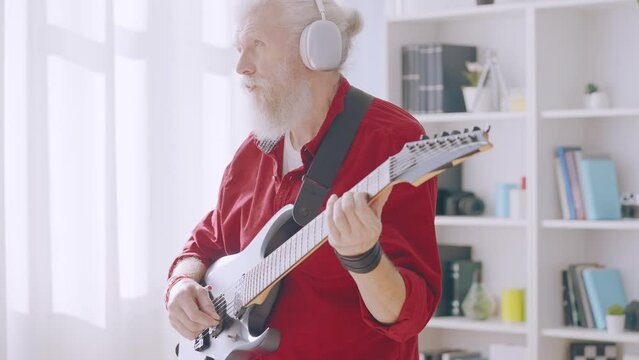 Contemporary senior man playing electric guitar, forever young, rock and roll