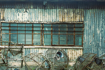 Abandoned fishing boat house and lobster pots