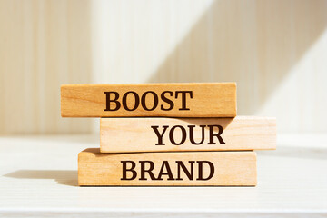 Wooden blocks with words 'Boost Your Brand'. Business concept