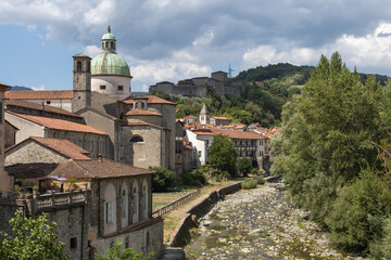 Pontremoli in the Massa Carrara region of Tuscany with the Cathedral of Santa Maria Assunta Dome and Castello del Piagnaro  in the background, the River Magra in the foreground.