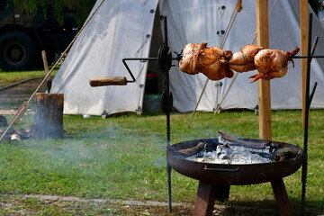 A close up on a large set of fried and grilled chickens prepared after covering them with a spicy...