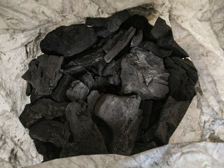 Heap of pieces of natural broken black charcoal