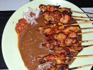 Malaysian chicken satay with delicious peanut sauce, one of famous local dishes.