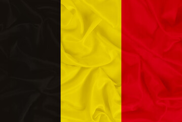 Fototapeta premium National flag of Belgium on textured fabric background with shadows, flag of Belgium