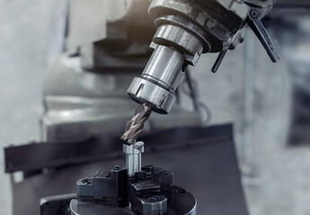 endmill cutting tool 4 flute. Material carbide. Coating Titanium nitride. In holder on milling machine. Used for metalwork.