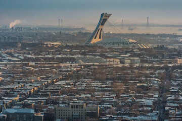 view on the Montreal Olympic stadium at sunrise in winter from Mount Royal (Quebec, Canada) - obrazy, fototapety, plakaty