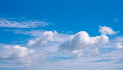 Naklejka na ściany i meble Beautiful cloudscape background of white fluffy clouds on blue sky 