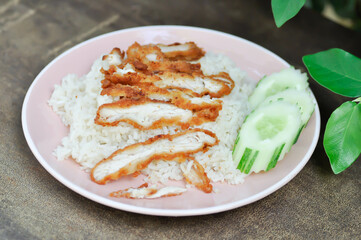 rice topped with chicken or chicken rice or fried chicken and rice