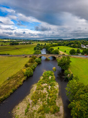 Aerial view downriver of the River Wharfe and Pool Bridge, Yorkshire