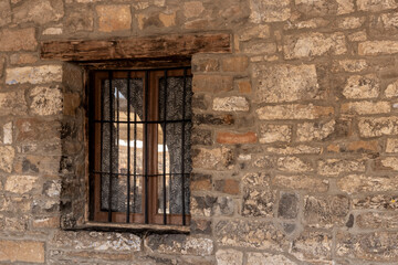 barred window in an old building