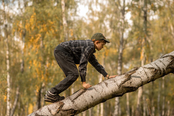 little boy is playing in the autumn woods