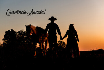 Silhouette of horse and gaucho family at sunset in South Brazil