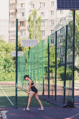 the girl does a warm-up using a rubber expander. Leg muscle training.