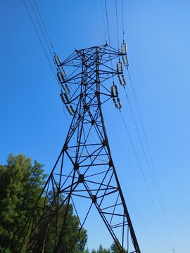 Power line, high-voltage electricity transmission tower against the sky, industrial background, wallpaper