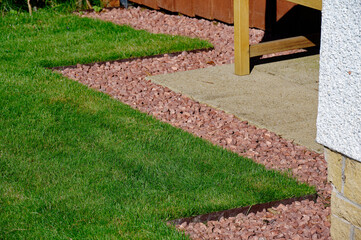 Lawn edging made of metal showing straight and neat finish - obrazy, fototapety, plakaty
