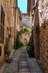 street in the medieval village of spello, umbria, italy