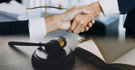 Judge gavel with Justice lawyers having team meeting at law firm in background. Concepts of law.