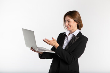 Young attractive and smiling business woman in black suit holding laptop isolated on white. Copy space and place for text concept