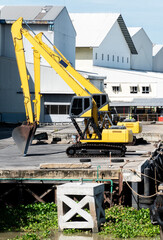 Two yellow backhoe on dock