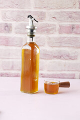 Mustard oil in a plastic jar on table 