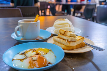 Traditional breakfast set and coffee, boiled eggs and toast, popular in Singapore