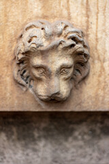 Fototapeta na wymiar old lion head knocker on a wall in Rome, Italy