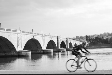 A biker and Memorial Bridge in black and white - Washington DC United States