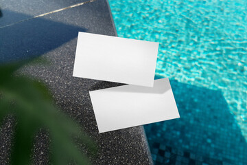 Clean minimal business card mockup on pool side with leaves background