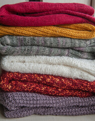 Autumn and winter background with knitted colourful sweaters