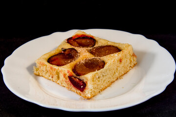 Plum-pie with cinnamon on a white plate